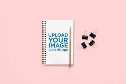 Mockup of a Notebook Lying on a Colorful Background Featuring a Pencil