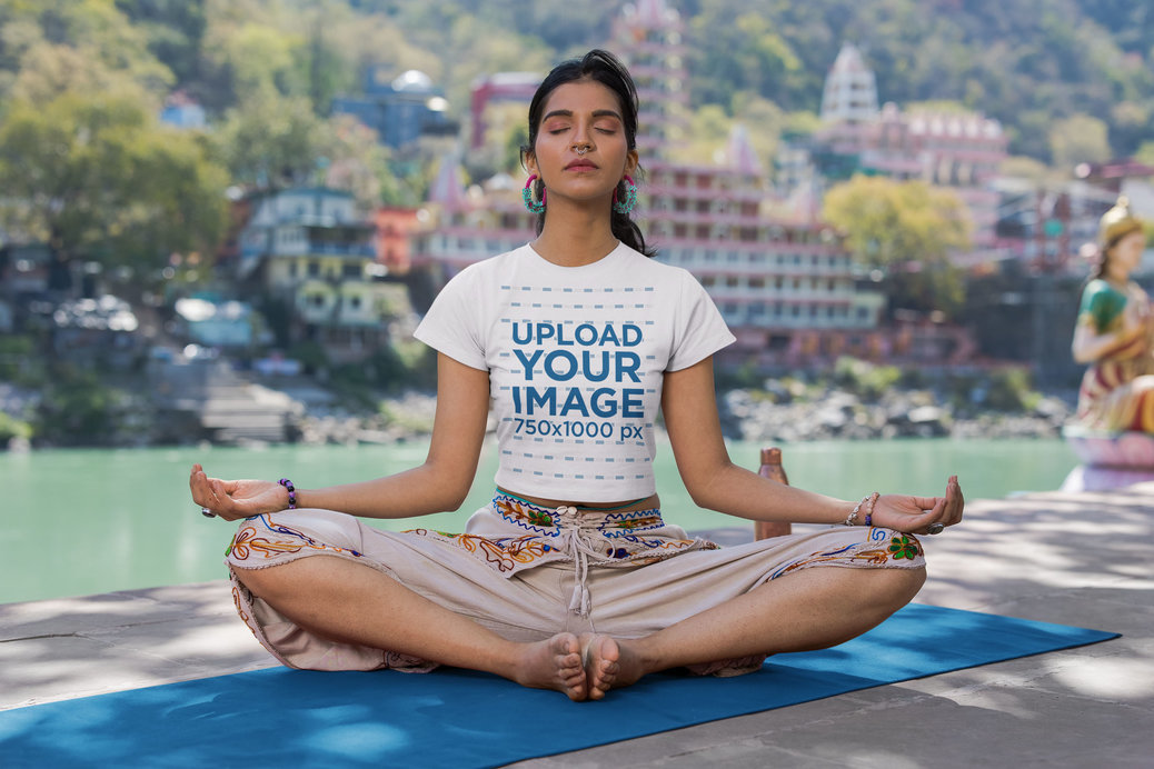 Crop Top Mockup of a Calm Woman Meditating Near a Lake