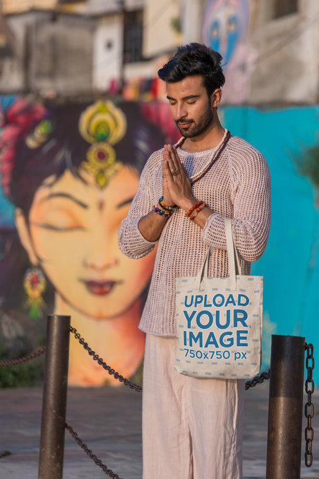 Tote Bag Mockup of a Calm Man Meditating in the Street