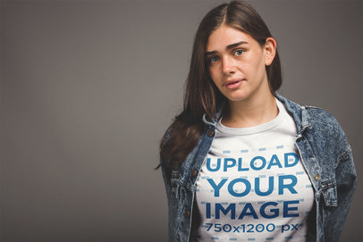 White Woman Wearing a T-Shirt Mockup and a Denim Jacket at a Studio