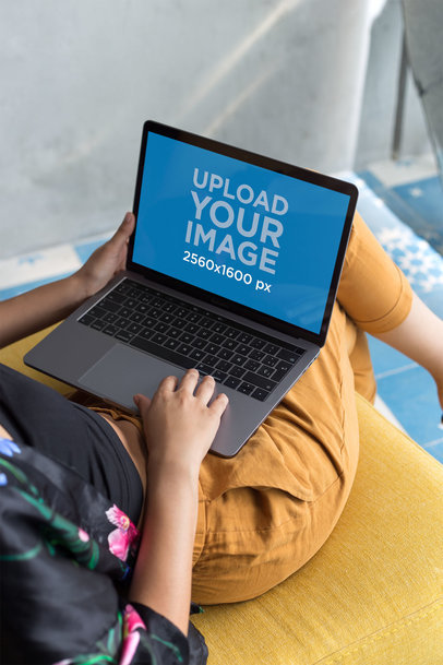 Mockup of a Woman Using a MacBook on her Lap