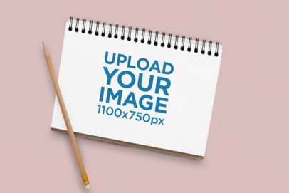 Notebook Mockup Featuring a Colorful Surface and a Brush