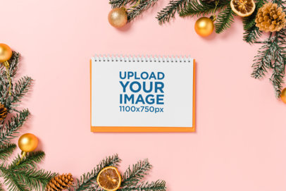 Mockup of a Notebook Placed on a Colorful Background With Christmas Ornaments m32121 r-el2