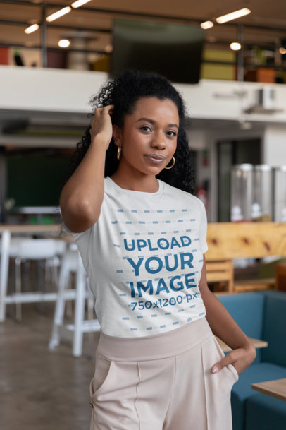Bella Canvas T-Shirt Mockup of a Curly-Haired Woman Posing in an Office