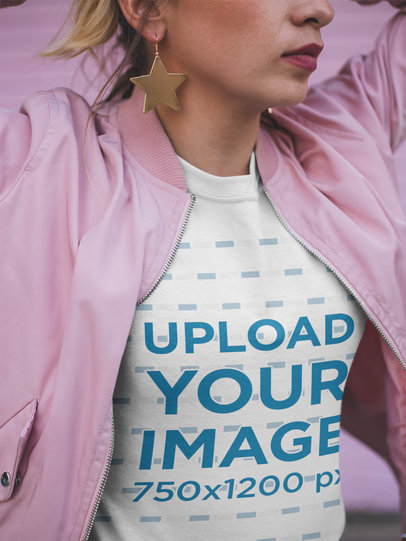 Closeup T-Shirt Mockup of a Woman Wearing a Pink Jacket and Star Earrings