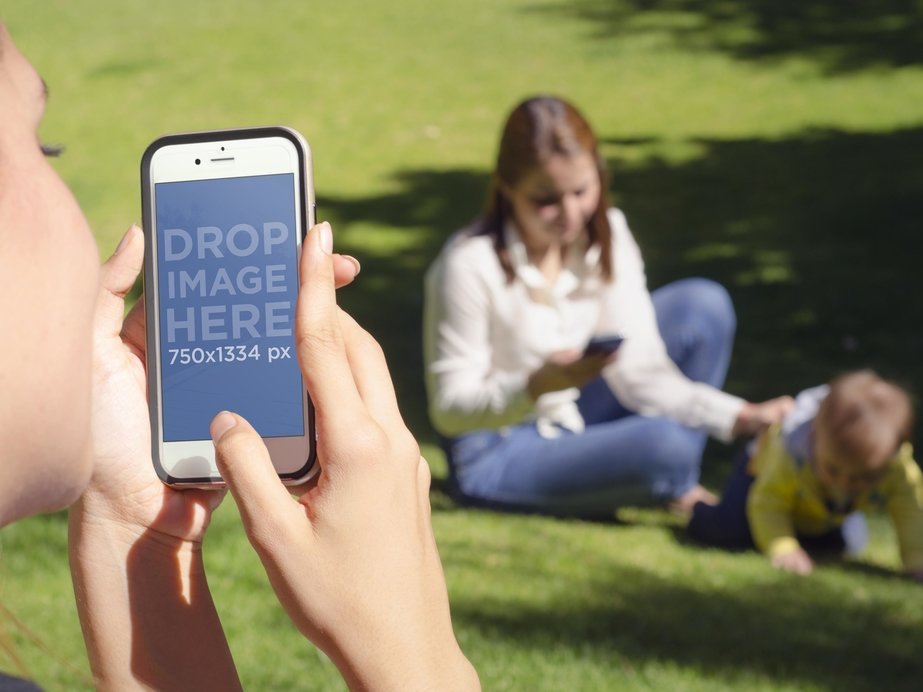 iPhone Mockup Featuring a Young Woman Taking a Picture