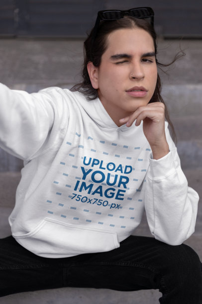 Gildan Pullover Hoodie Mockup of a Long-Haired Man Winking His Eye