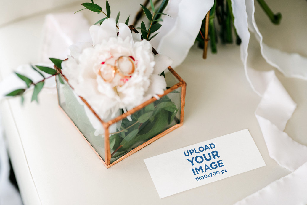 Wedding Program Mockup Featuring Floral Decorations and a Pair of Rings
