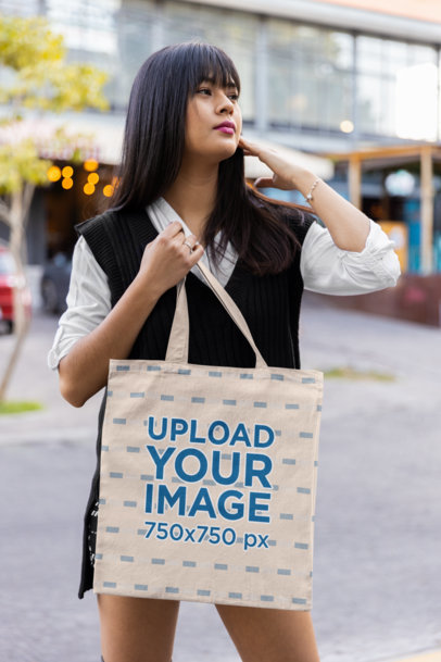 Tote Bag Mockup Featuring a Woman Posing on the Street