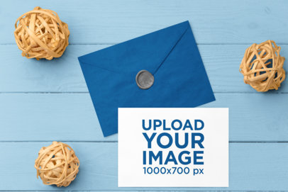 Mockup of a Postcard Lying on a Wooden Background Featuring an Envelope