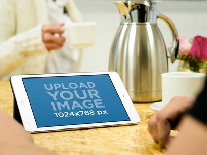 Mockup of an iPad Featuring a Couple Having a Coffee m34481