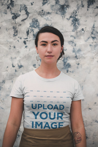 Mockup of a Woman with a Tattoo and Hula Hoop Earrings Wearing a T-Shirt