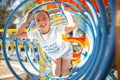 T-Shirt Mockup of a Happy Girl at the Playground