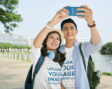 Phone Case Mockup Featuring a Couple Wearing Round-Neck T-Shirts While Taking a Selfie m34236 r-el2