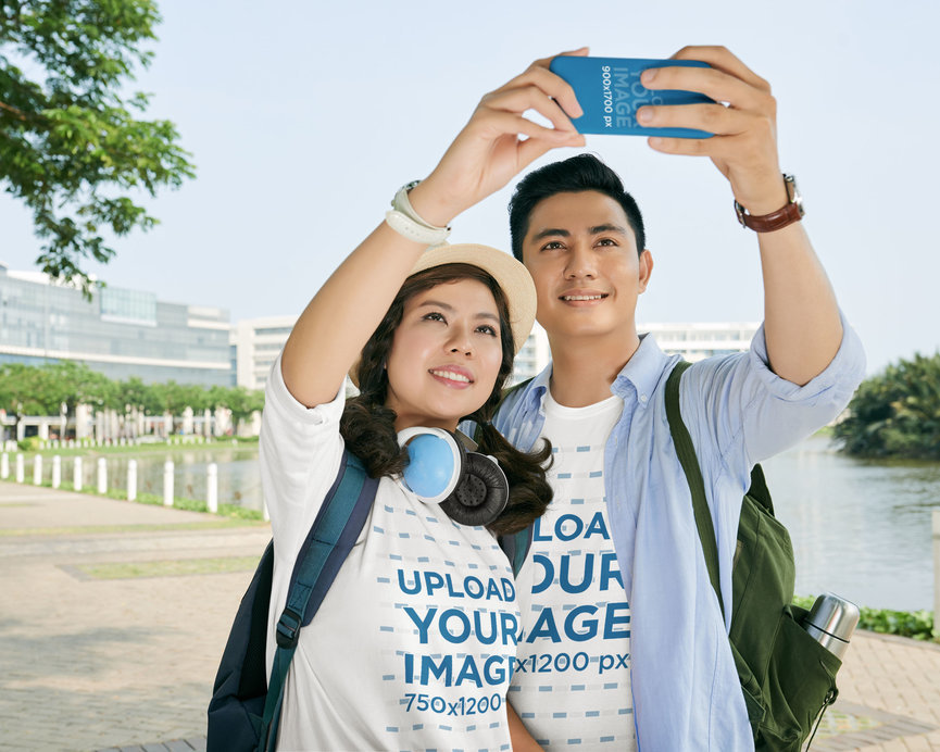 Phone Case Mockup Featuring a Couple Wearing Round-Neck T-Shirts While Taking a Selfie
