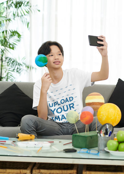 Round-Neck T-Shirt Mockup Featuring a Teenage Boy Taking a Selfie