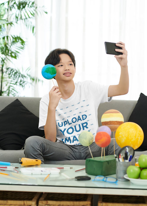 Round-Neck T-Shirt Mockup Featuring a Teenage Boy Taking a Selfie