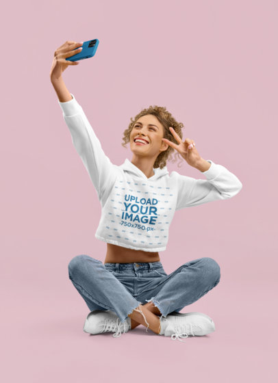 Crop Top Hoodie Mockup of a Joyful Woman Taking a Selfie in a Studio m28283 r-el2