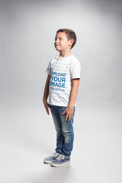 T-Shirt Mockup of an Asian Boy Standing in a Photo Studio