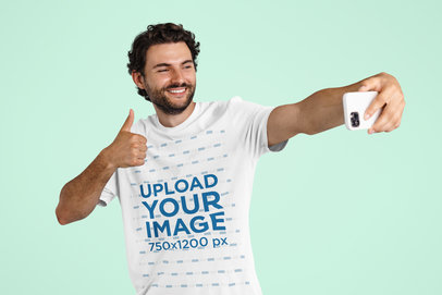 T-Shirt Mockup of a Bearded Man Taking a Selfie of Him Giving a Thumb-Up