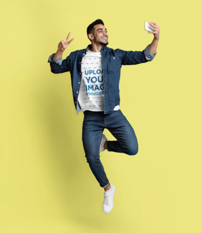 Round-Neck T-Shirt Mockup Featuring a Man Taking a Selfie While Jumping