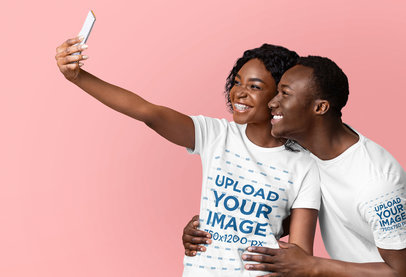 T-Shirt Mockup of a Cheerful Couple Taking a Selfie in a Studio