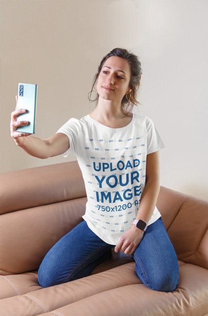 T-Shirt Mockup of a Woman Taking a Selfie on a Couch