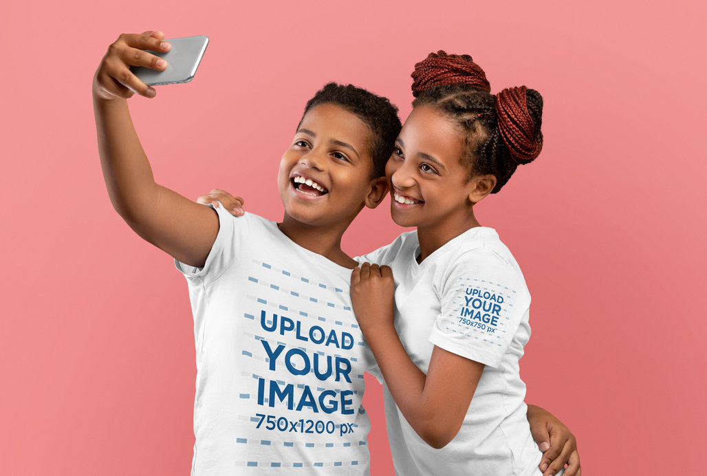 T-Shirt Mockup Featuring Two Happy Siblings Taking a Selfie at a Studio