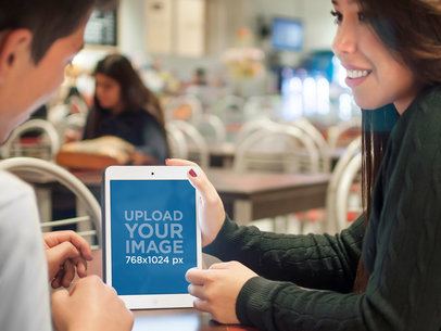 Mockup of a Teenage Girl Using an iPad at the School Cafeteria