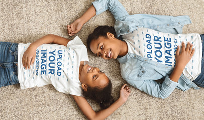 Siblings Day-Themed T-Shirt Mockup of Two Smiling Sisters Lying on the Floor 