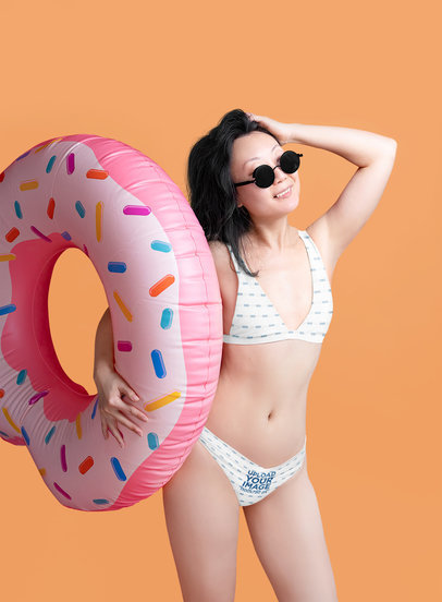 Bikini Swimsuit Mockup Featuring a Happy Woman With a Donut Inflatable Ring
