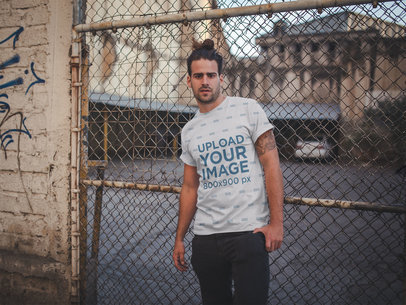 Sublimated T-Shirt Mockup of a Man Standing Outside a Downtown Parking Lot