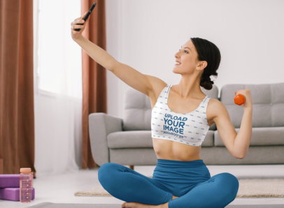 Sports Bra Mockup of a Woman Taking a Selfie During Her Home Workout