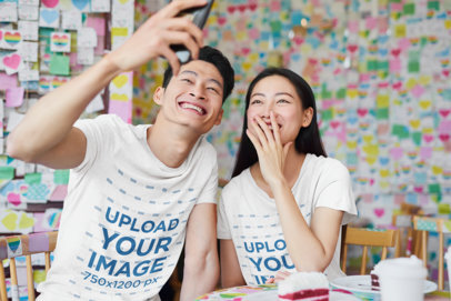 T-Shirt Mockup Featuring a Smiling Couple Taking a Selfie