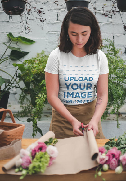 T-Shirt Mockup Featuring a Woman Working at a Flower Shop