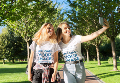 T-Shirt Mockup Featuring a Mom and Her Daughter Taking a Selfie at a Park m21827 r-el2