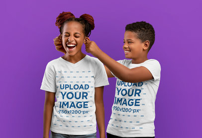 T-Shirt Mockup of Two Siblings Happily Playing in a Studio