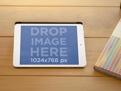 Mockup of an iPad in Landscape Position on a Wooden Table