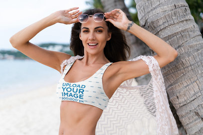 Bikini Mockup of a Happy Woman Wearing Sunglasses at the Beach