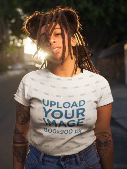 T-Shirt Mockup Featuring a Young Woman with Locs on the Street