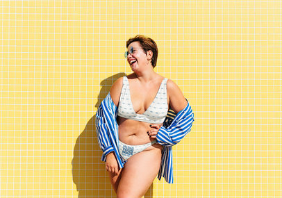 Mockup of a Happy Woman Posing in a Sublimated Bikini
