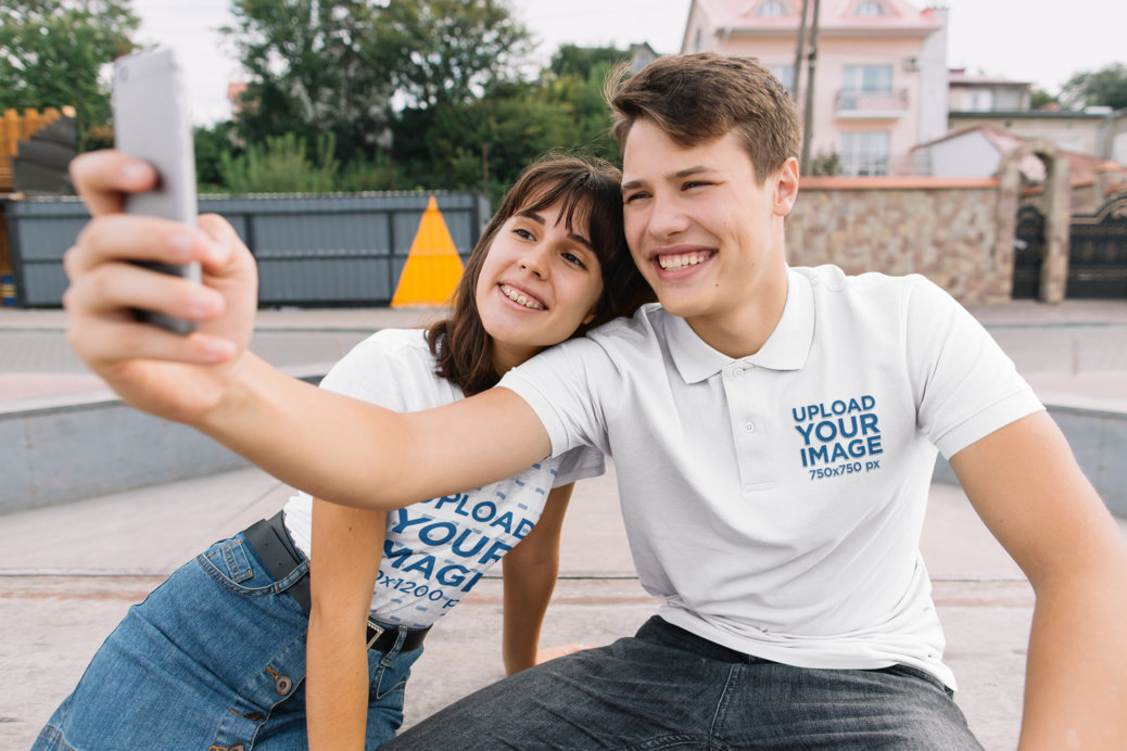 Polo Shirt and T-Shirt Mockup Featuring a Smiling Couple Taking a Selfie in the Suburbs