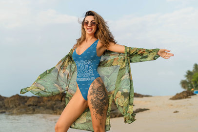 One-Piece Bikini Mockup of a Woman with a Leg Tattoo at the Beach