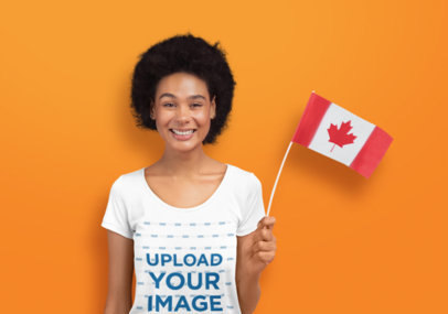 T-Shirt Mockup of a Cheerful Woman Holding a Canadian Flag