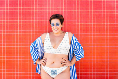 Bikini Mockup of a Smiling Woman Posing Against a Red Wall
