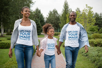 T-Shirt and Tank Top Mockup Featuring a Happy Family Holding Hands and Walking