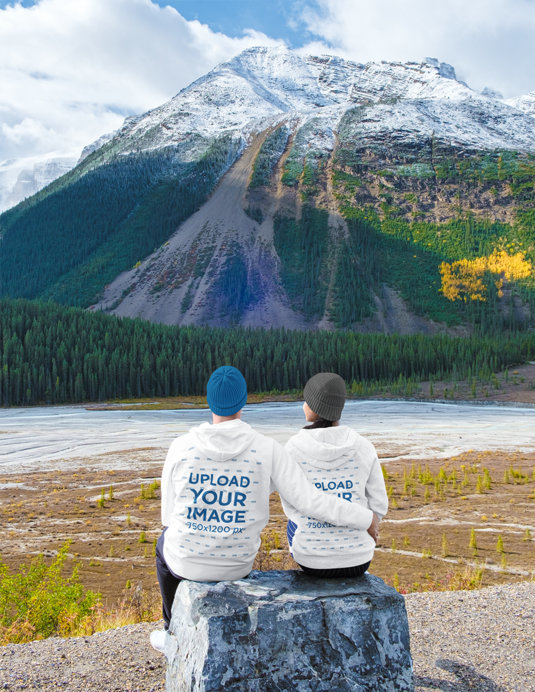 Canada Day-Inspired Hoodie Mockup Featuring a Couple Admiring a Mountain