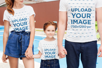 Round-Neck T-Shirt Mockup Featuring a Little Smiling Girl Holding Her Parents' Hands
