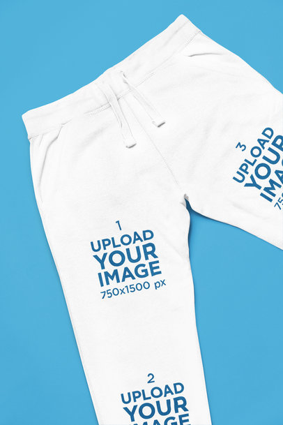 Mockup of a Pair of Sweatpants Lying on a Colorful Surface m33402