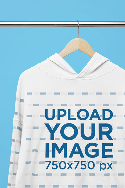 Mockup of a Bella Canvas Crop Top Hoodie Placed on a Wooden Hanger